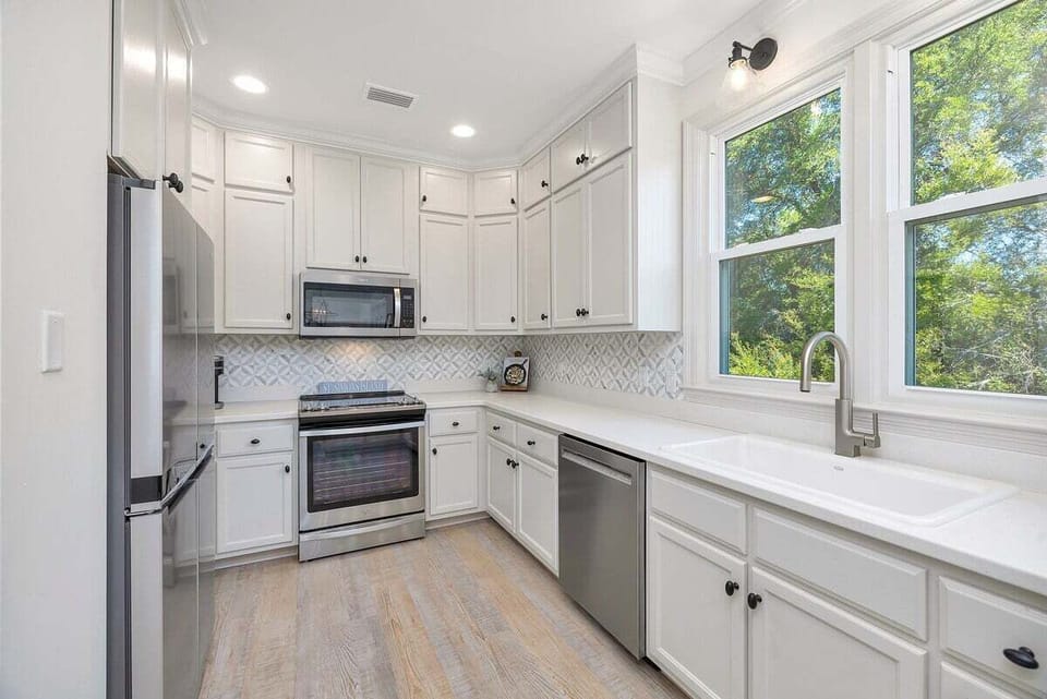 Close up of kitchen area with stainless steel appliances and sink