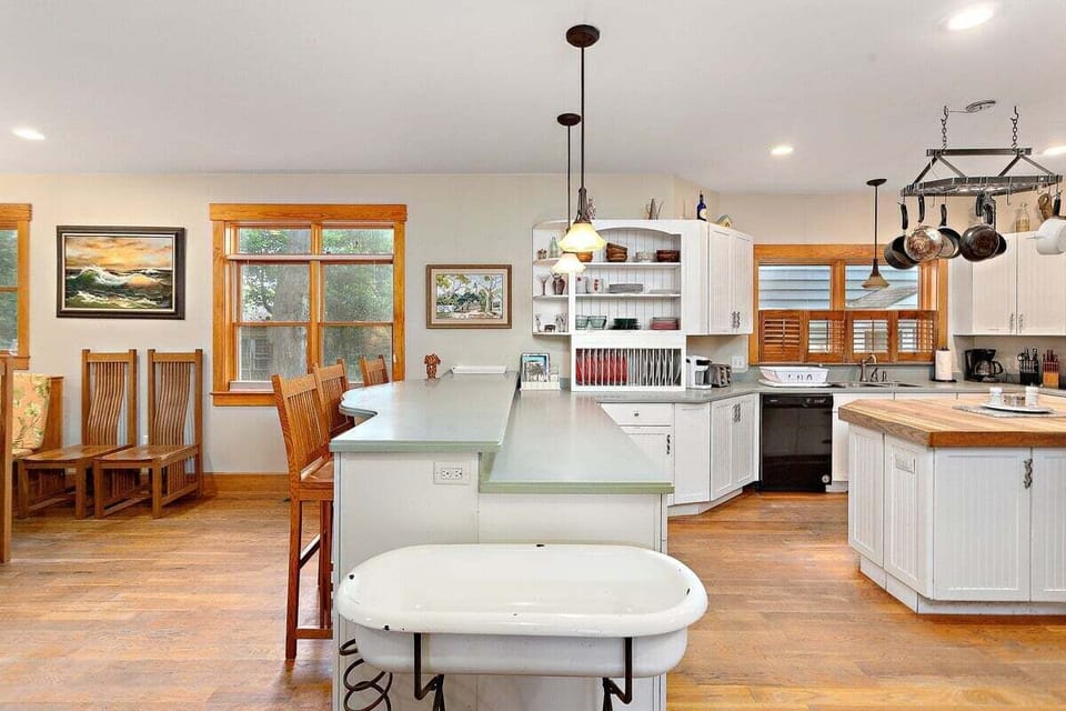 Spacious kitchen with island, pendant lights, and wood floors