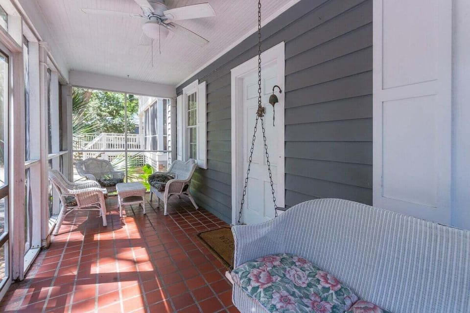 Covered porch with porch swing and wicker chairs