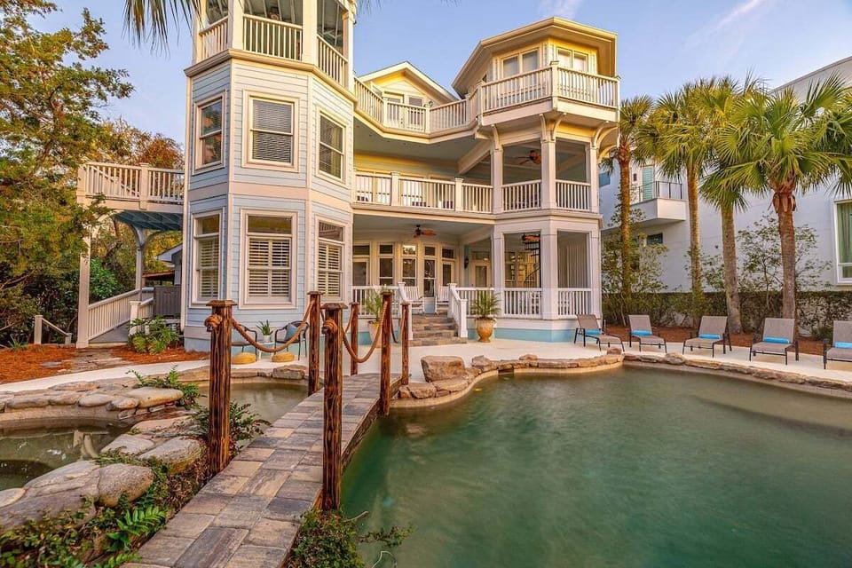 Lagoon pool with rope bridge and tropical palm trees