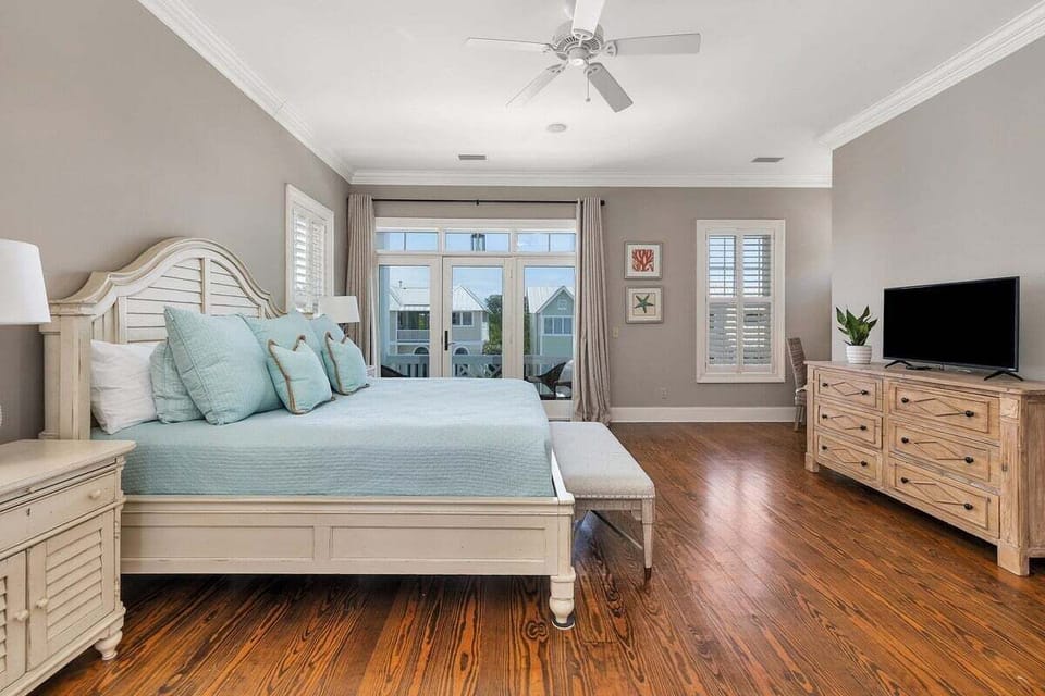 Master bedroom with blue-toned bedding and chest of drawers