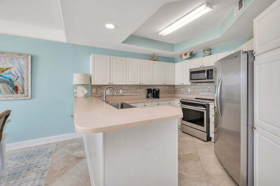 Saint Simons Grand #323 Kitchen with French Door Refrigerator, Electric Stove, and Over-the-Range Microwave