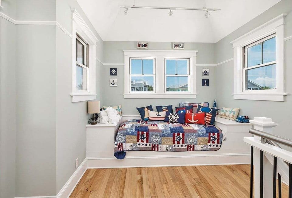 Third floor loft with daybed and surrounding windows