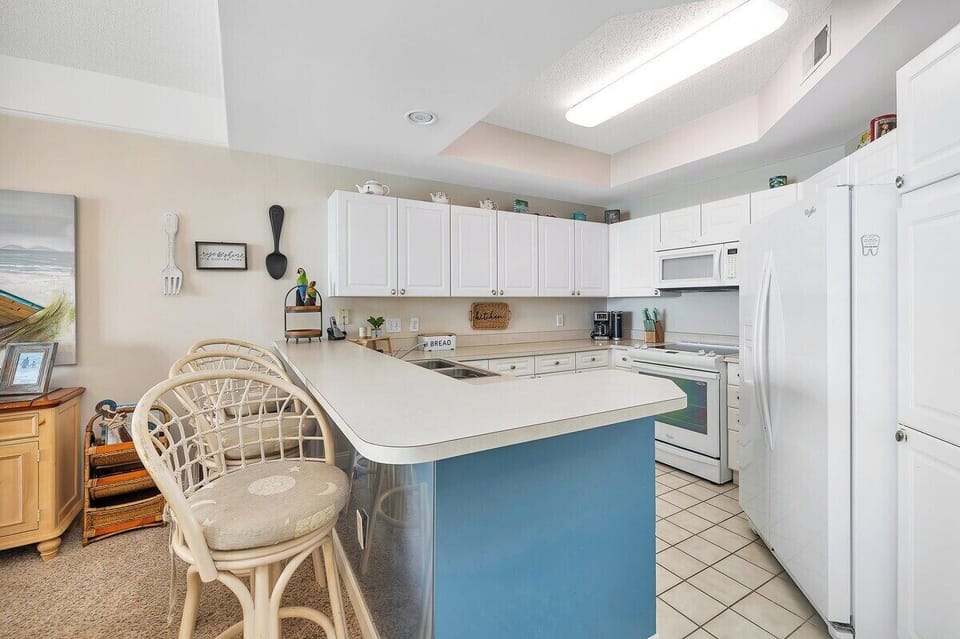 Saint Simons Grand #112 Kitchen with French Door Refrigerator, Electric Stove, and Over-the-Range Microwave