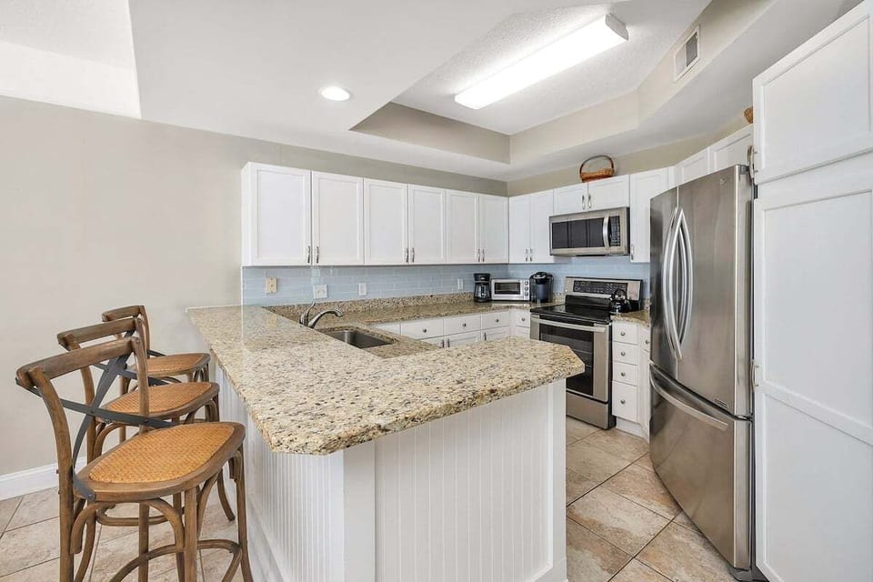 Saint Simons Grand #321 Kitchen with French Door Refrigerator, Electric Stove, and Over-the-Range Microwave