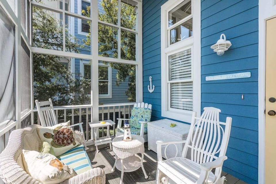 Front screened porch with white wooden outdoor furniture