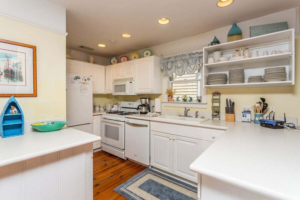 Open concept kitchen with white cabinetry
