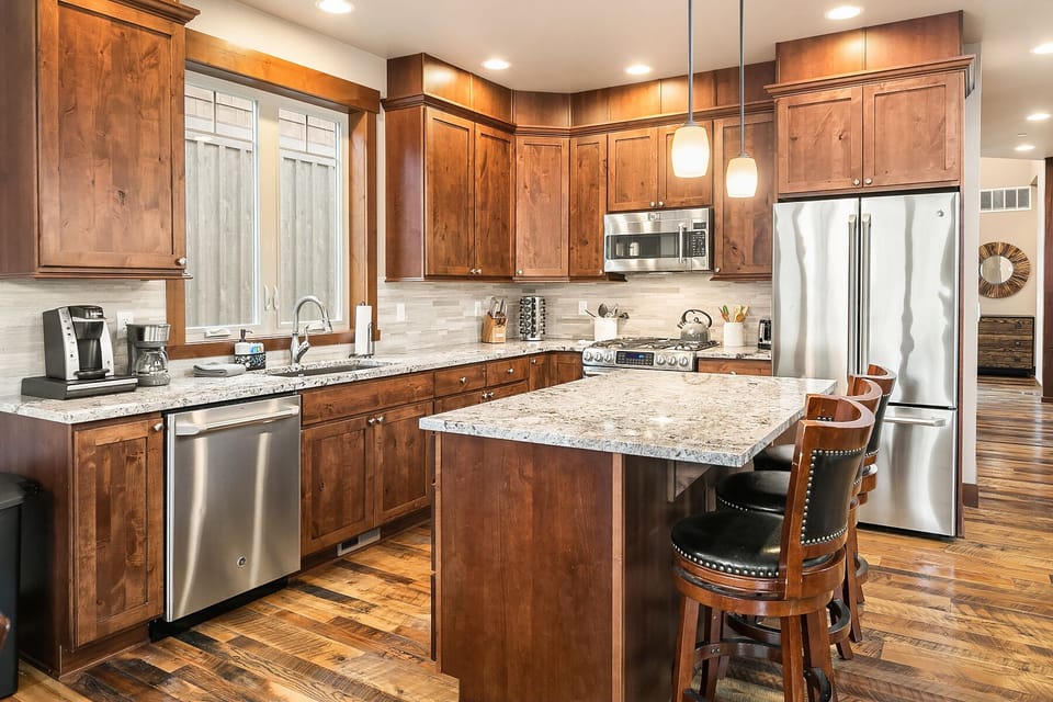 Latitude Adjustment: - Fully stocked chef's kitchen with a large center island and seating for 3.