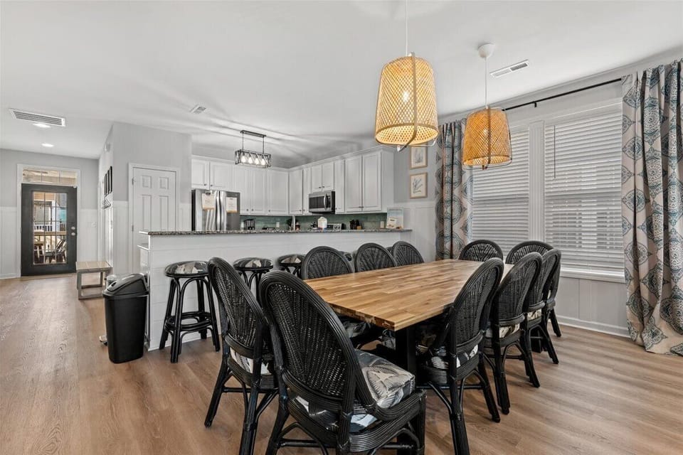 Gather around this spacious dining table where memorable meals and conversations await your group in this bright, open-concept space.