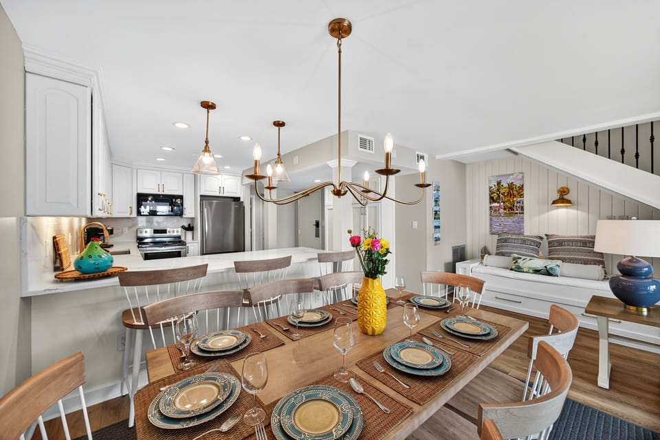 Open concept kitchen stocked with everything you need leading into the elegant dining table.