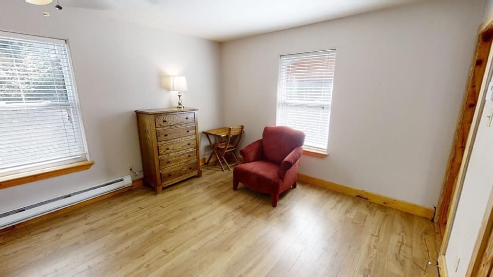 Unwind in your bright reading nook, where a cozy armchair and natural light create the perfect spot to relax with a book or morning coffee.