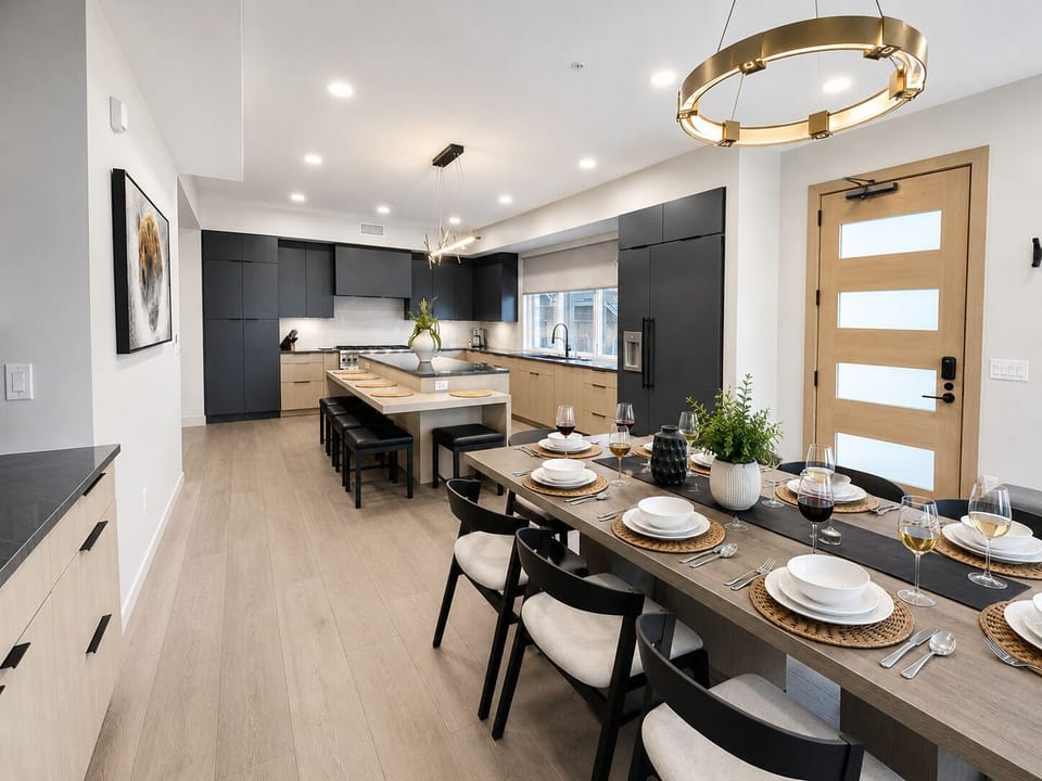 Gather around your elegant dining table set for six, then step into your modern kitchen with spacious island seating. Warm wood tones and sleek design invite effortless cooking and memorable meals together.
