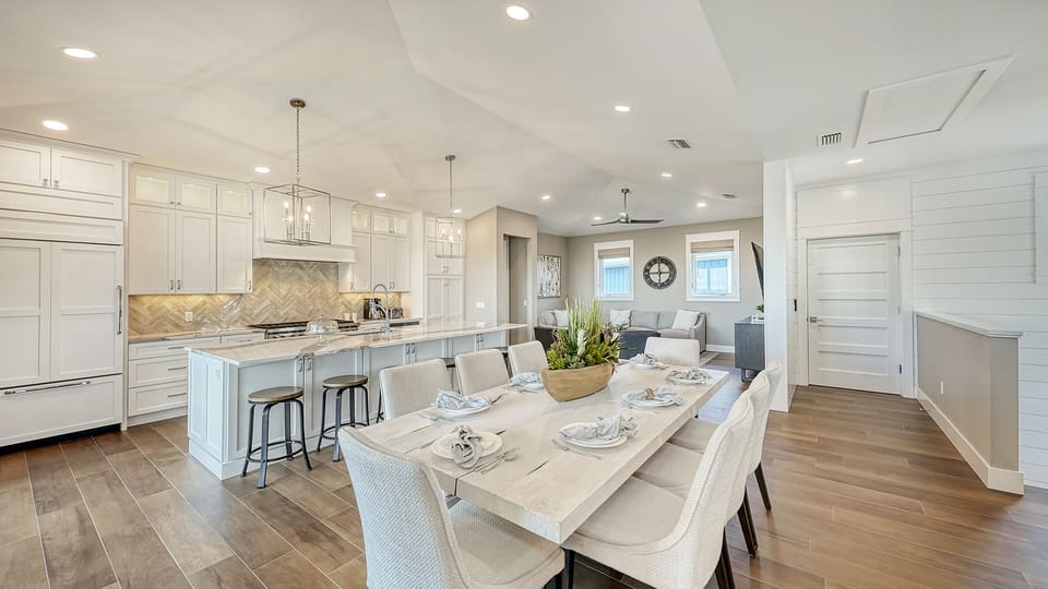 Gather, graze, and toast to good times—this open kitchen and dining area brings everyone together with style and space to spare.