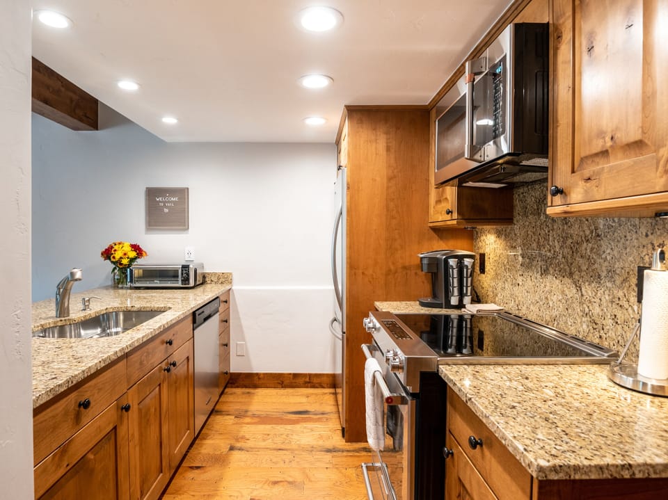 Kitchen is well stocked with quality kitchen supplies.