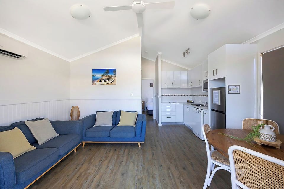 Standard Cabin - Sleeps 4 | Living area | Flat-screen TV, DVD player