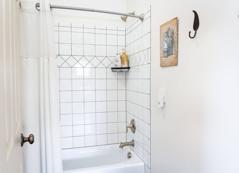New bathroom with tub/shower combo.