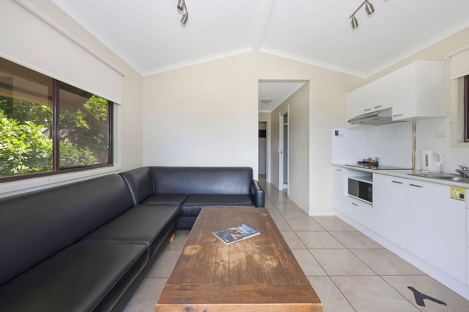 Standard Cabin - Sleeps 6 | Living area | Flat-screen TV