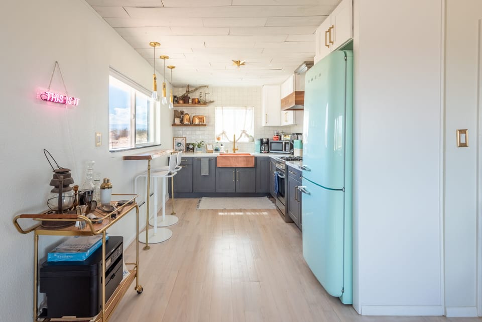 Full kitchen with green Smeg fridge, dishwasher, breakfast bar, fully equipped