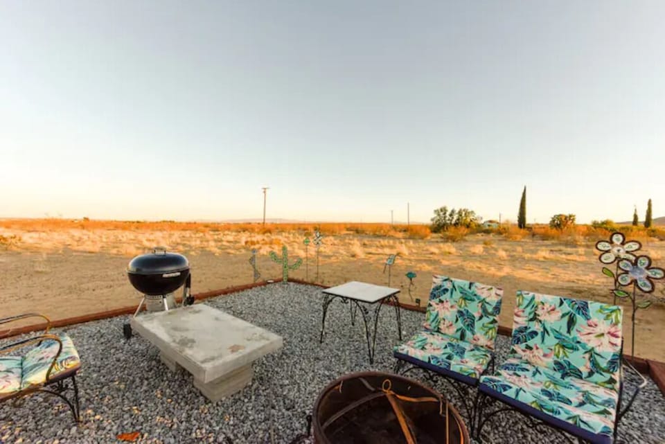Outdoor sitting area with firepit and charcoal grill