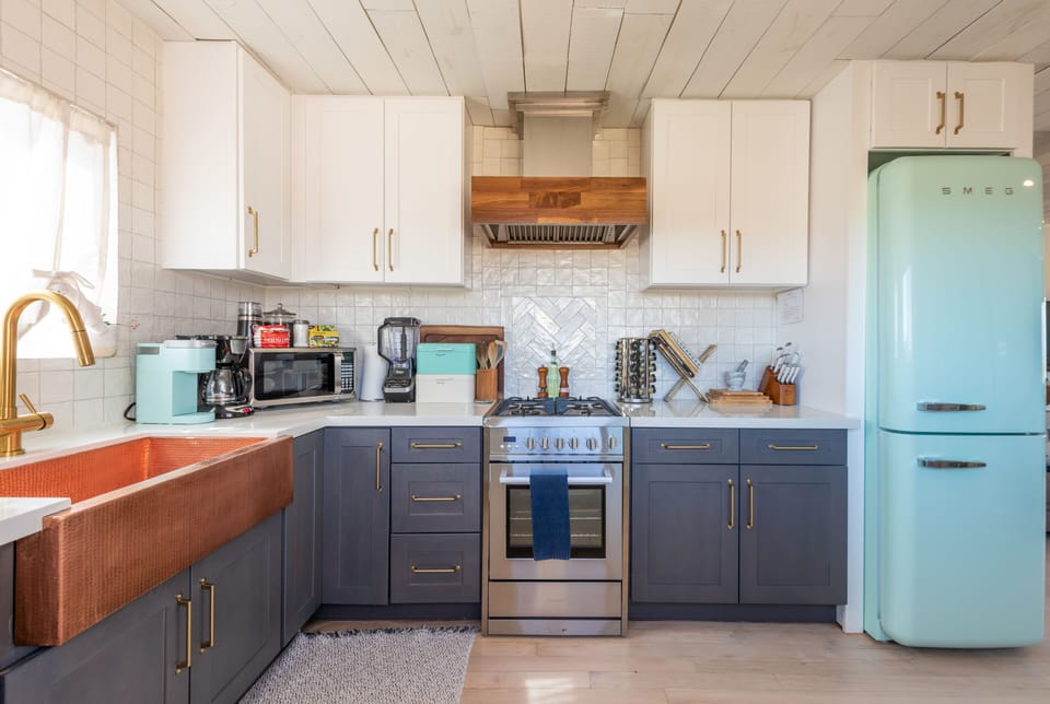 Full kitchen with green Smeg fridge, dishwasher, breakfast bar, fully equipped