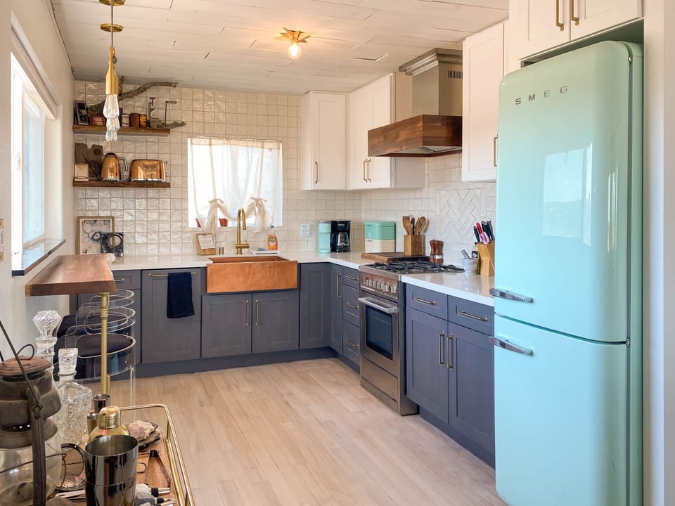 Full kitchen with green Smeg fridge, dishwasher, breakfast bar, fully equipped