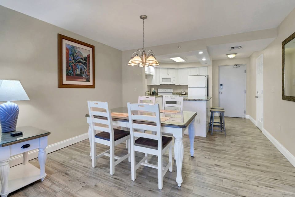 Gather round for a meal or a game of cards at the dining table with seating for 4 in the main living space.