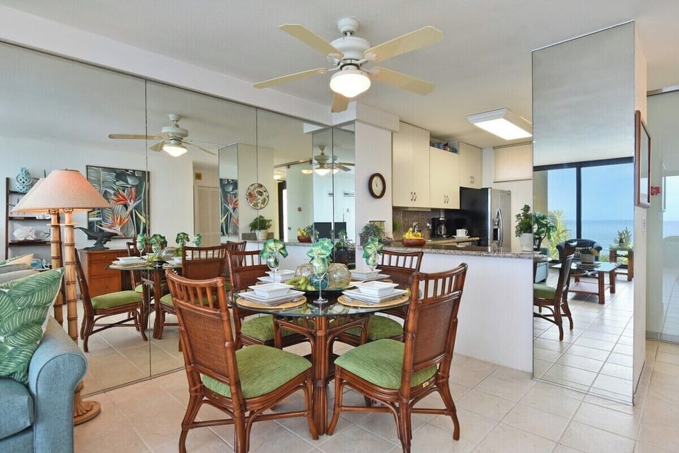 Enjoy meals in a sunlit dining area with tropical accents and seating for six, perfect for family gatherings