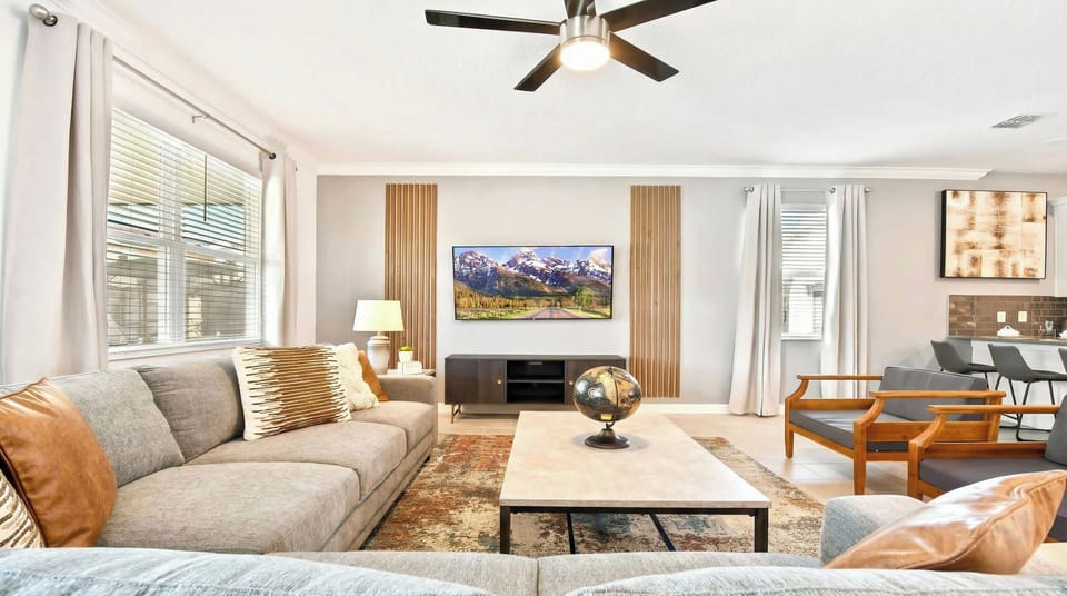 Generously sized living room featuring a cozy sofa, creating an inviting and comfortable space ideal for cherished family reunions and quality time together.