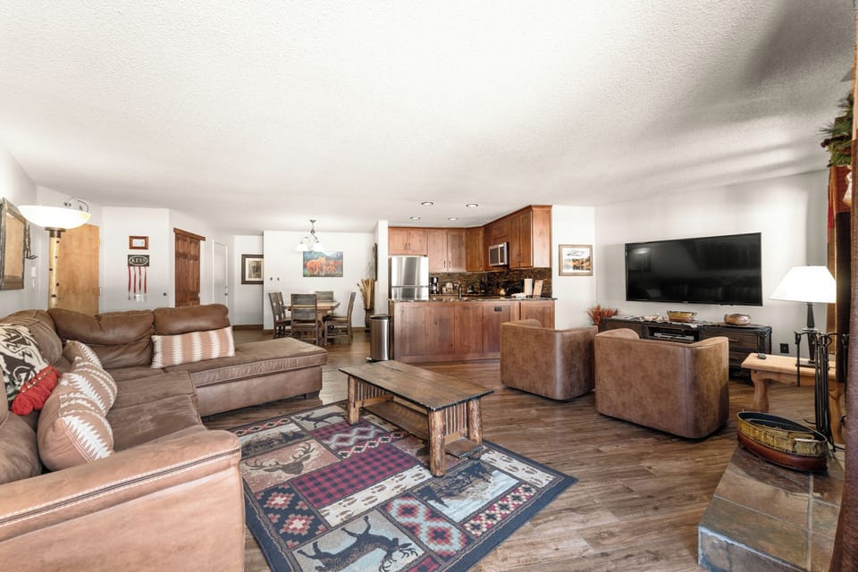 Sink into plush leather seating in your spacious open-concept living area, complete with full kitchen and modern entertainment center for perfect mountain getaway evenings.