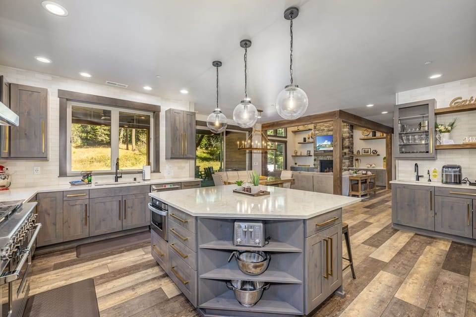 Kitchen – Oversized Island + Pendant Lighting + Open Shelving.