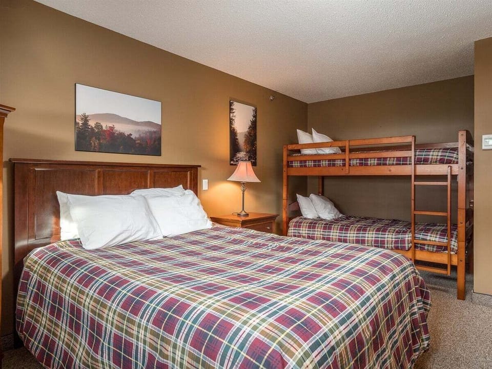 Bedroom with queen size bed and set of bunks