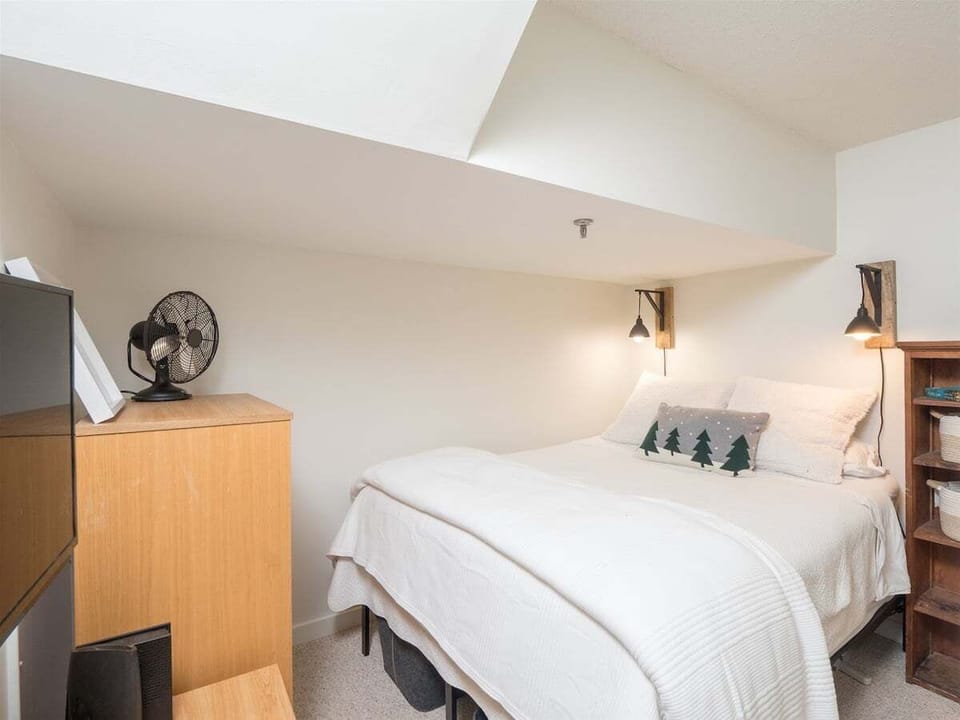 second of two queen beds separated by partial wall
