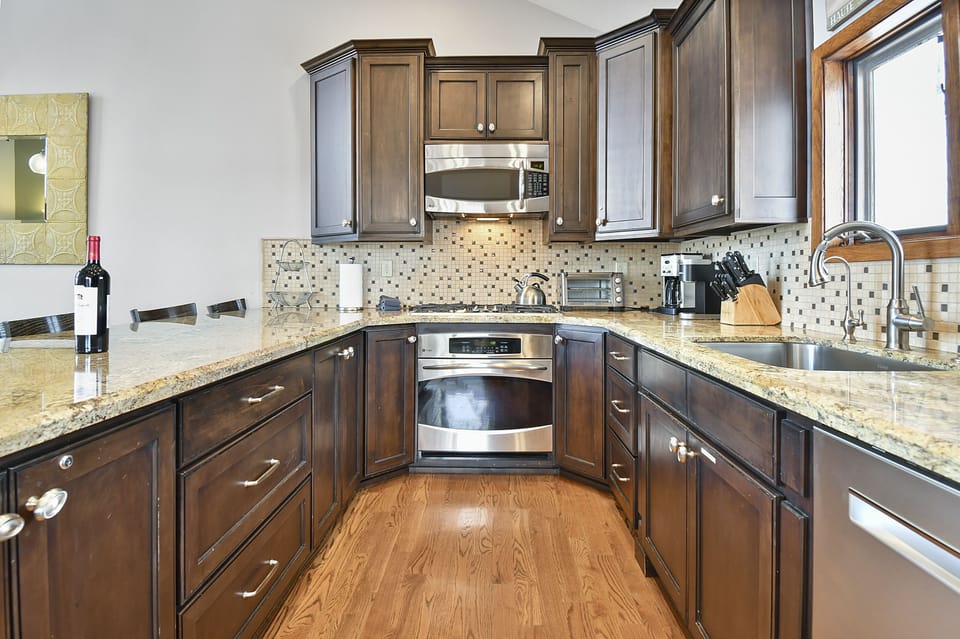 Deluxe Townhome | Private kitchen | Full-size fridge, microwave, oven, stovetop