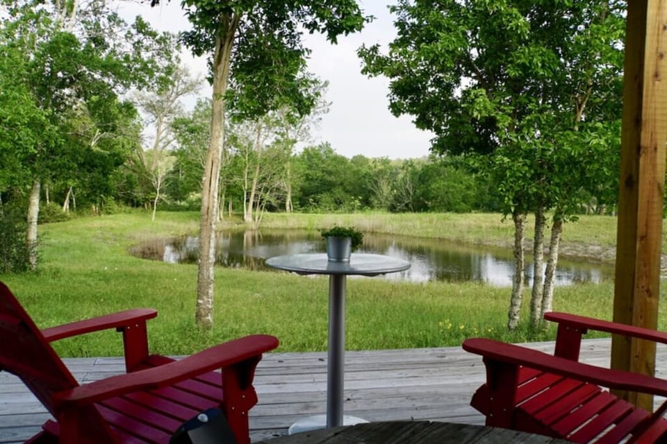 Covered private porch overlooking pond