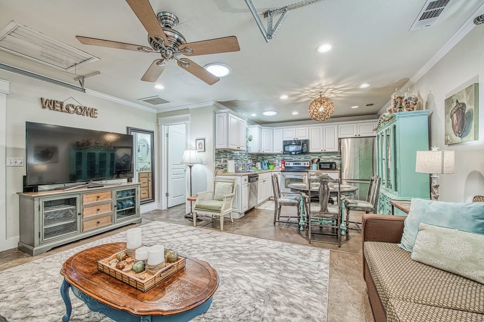 view of kitchen towards dining area and kitchen. bathroom on left 65 in tv