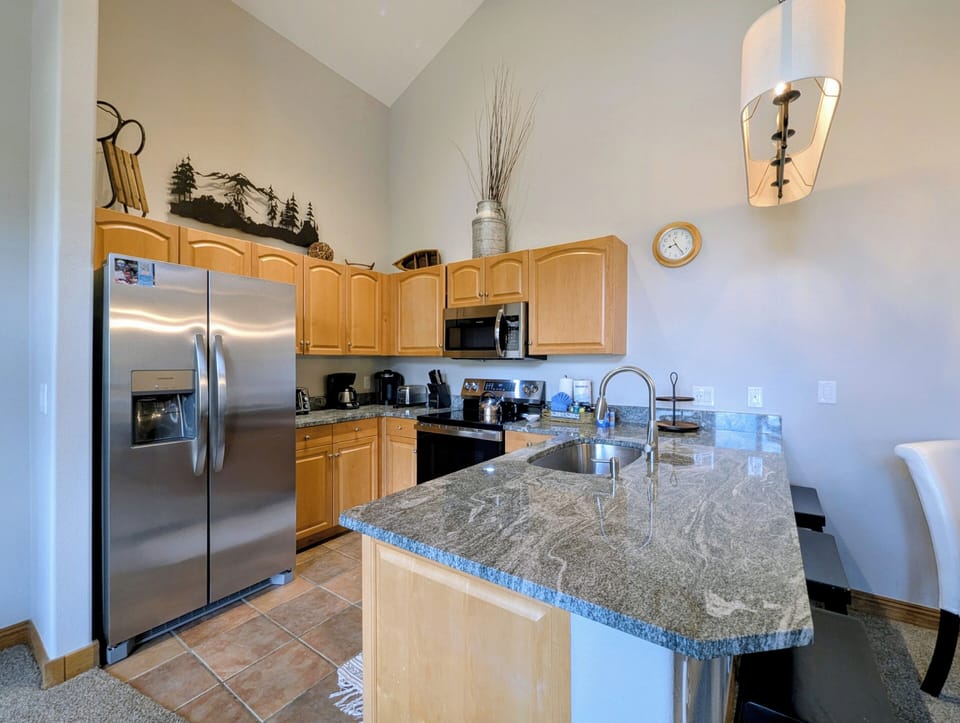 Your fully equipped kitchen features granite countertops, stainless steel appliances, and everything you need to create memorable meals together.