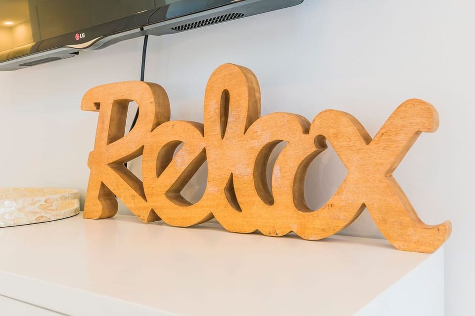 A cheerful wooden "Relax" sign greets you, setting the perfect tone for your stay. Settle in and let all your worries melt away in this welcoming space.