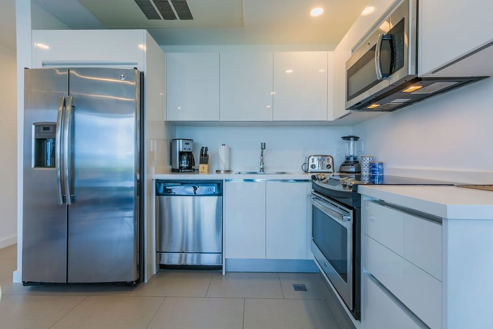 Your sleek, modern kitchen features stainless steel appliances, glossy white cabinetry, and all the tools you need to whip up delicious meals during your stay.