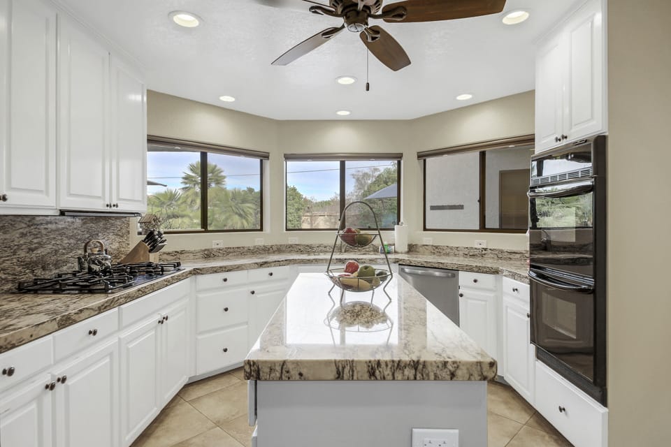 Appliances include a Frigidaire side-by-side refrigerator with a water and ice dispenser and granite countertops.