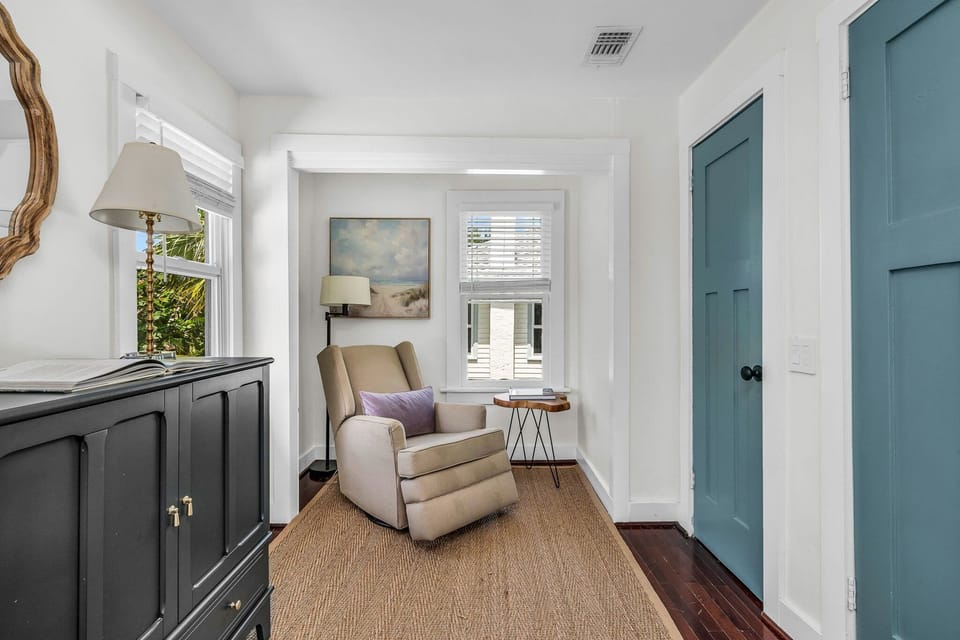 The primary bedroom in the main house features a queen bed, large his & her California Closets, and a dresser, which provide ample space and storage.