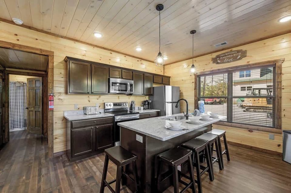 Modern state of the art Fully functioning Kitchen and large granite countertop with seats