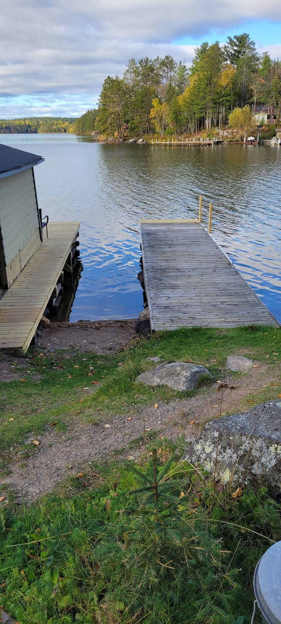 Small sandy beach between docks for swimming (rare on rocky lakeshore)