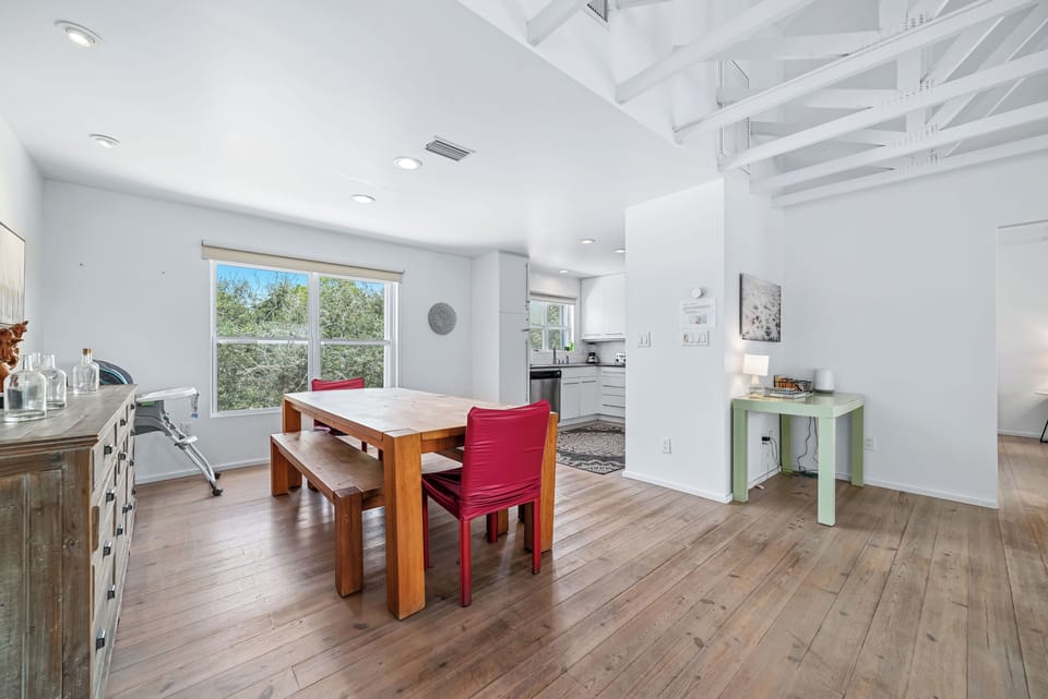 Rustic wood dining table with bench seating, brightened by natural light!