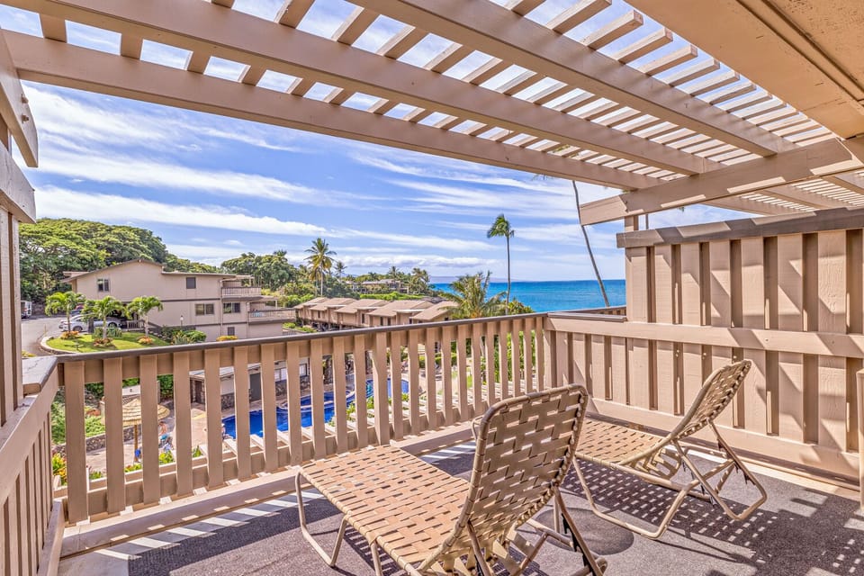 Lanai Living just off the main bedroom of this Maui Vacation ren - Primary bedroom lanai/balcony with 2 loungers to enjoy the tropical breezes and views.
