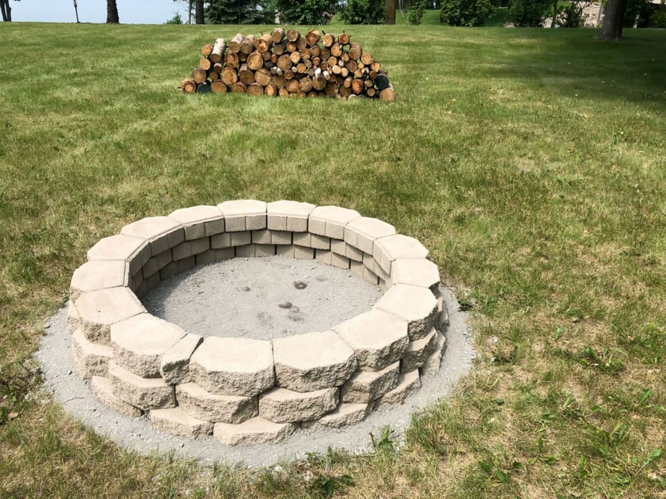 Fire pit with a starter supply of firewood.
