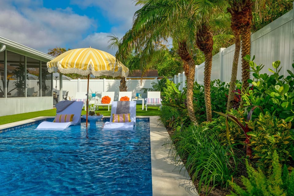 Resort-style pool surrounded by palms and lush landscaping for a private tropical feel.