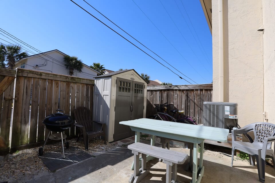 Private patio with outdoor seats, charcoal grill, beach chairs/toys, & bikes.