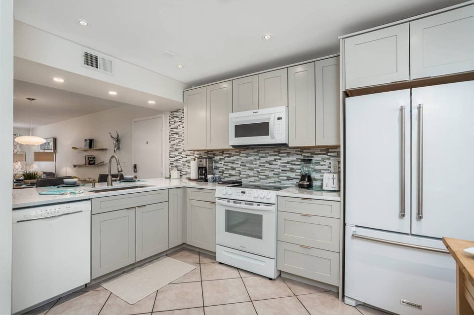 Beautiful kitchen with new counters and cabinets....stocked with dishes, glasses and all basic cooking essentials.  No perishables.