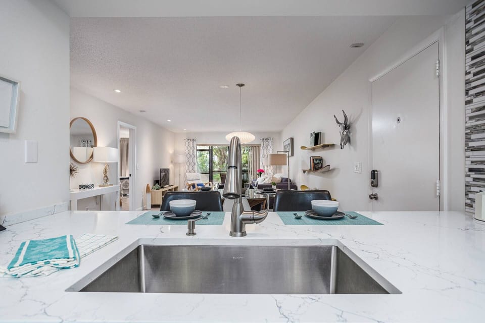 Beautiful new kitchen is open to the main living space...newer cabinets, solid stone counters & appliances.