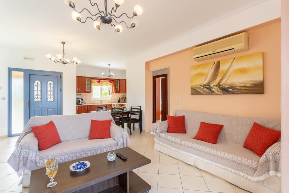 Open-plan living room with sofas, dining area, kitchen, A/C, WiFi internet, satellite TV, and terrace access